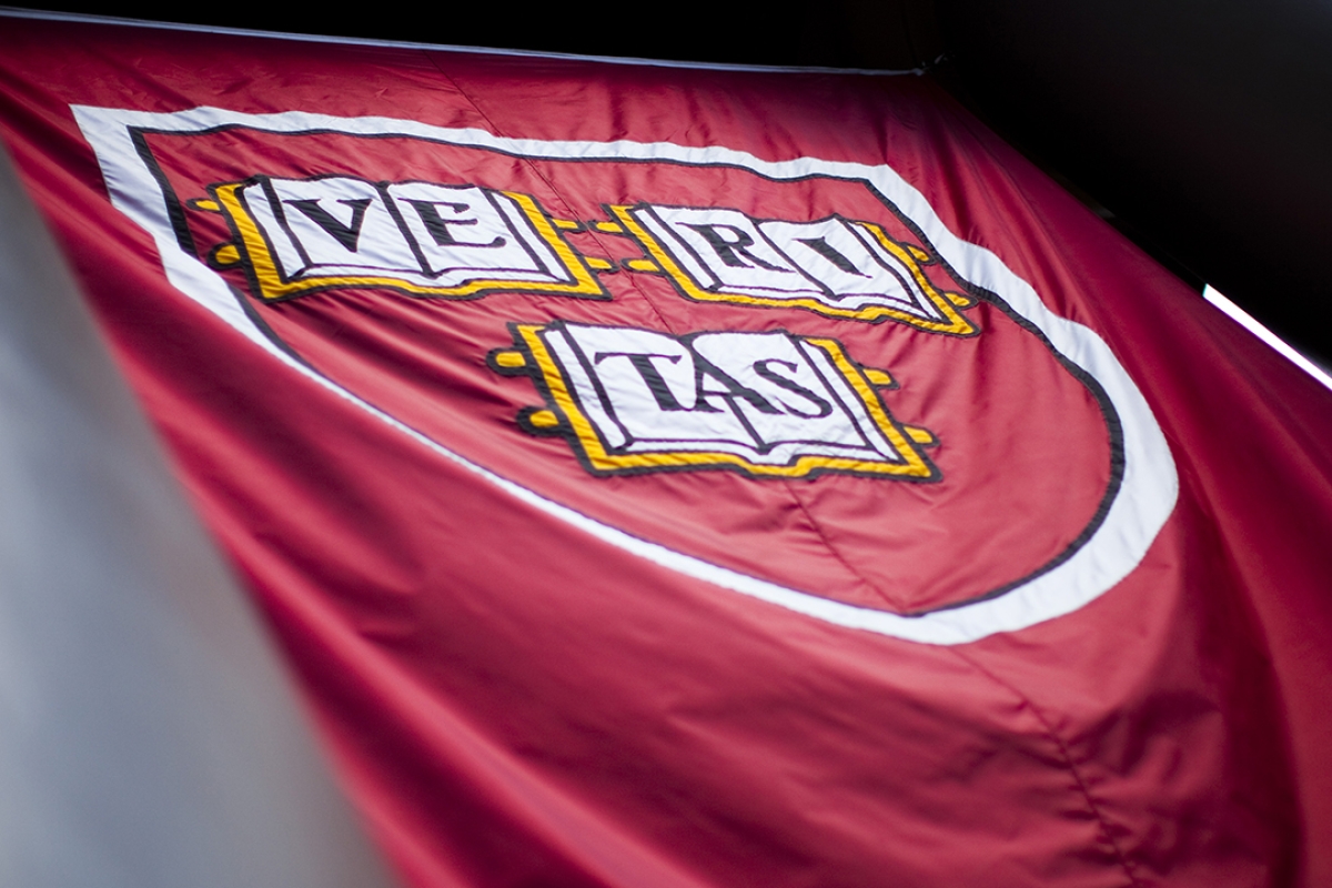 Harvard Women in Defense, Diplomacy, and Development Alumni Network - Image of crimson Veritas flag in the wind