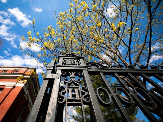 The gate along Quincy Street, featuring an "H" and Veritas shield